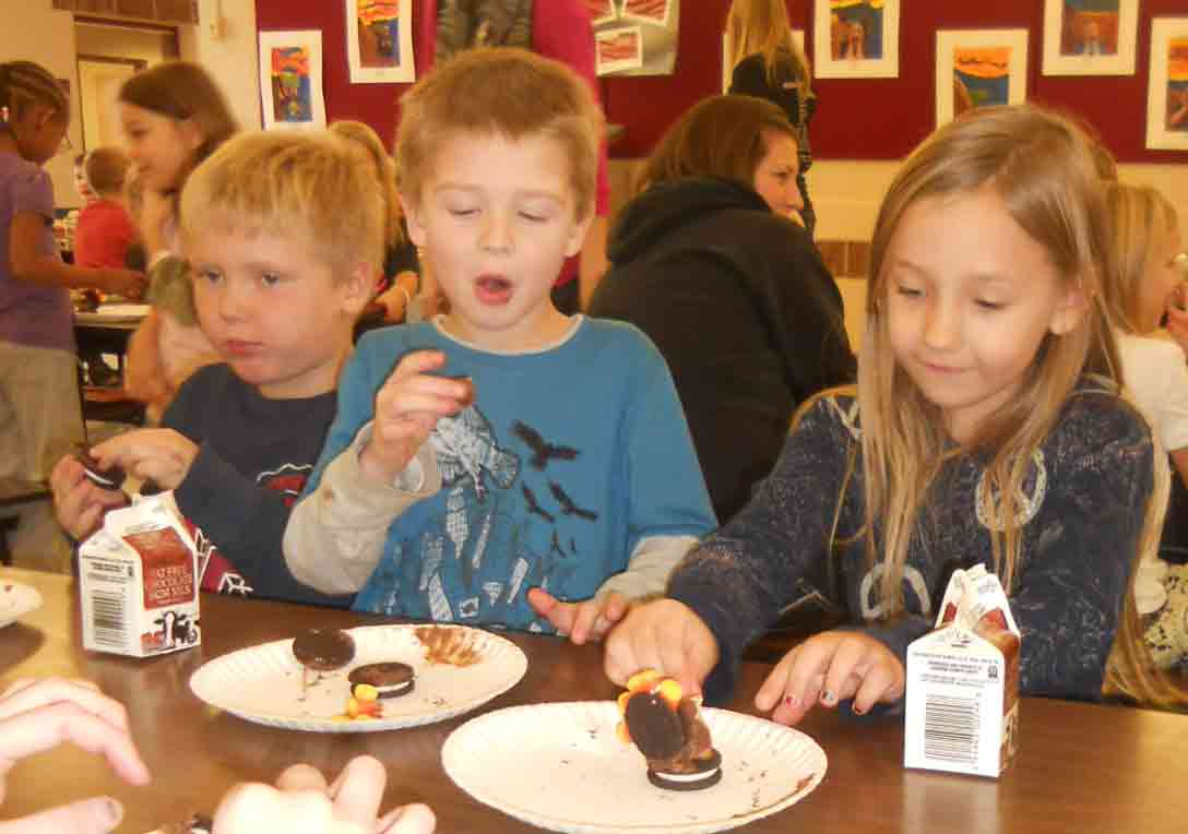 first graders enjoying cookies